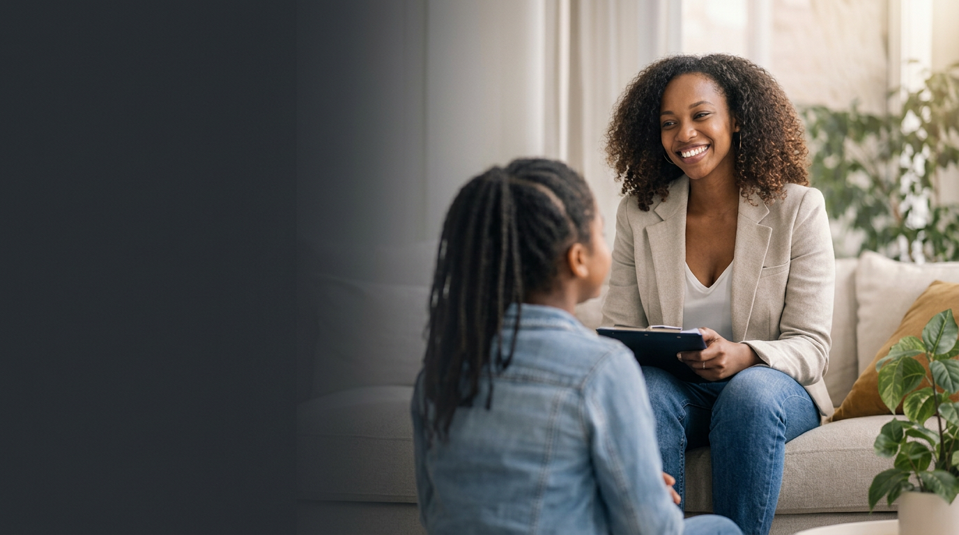 A therapist listening with warmth to a client in a sunlit counseling office